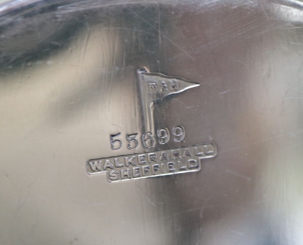 A group of small silverware including small waiter, three condiments, ashtray and minor flatware.